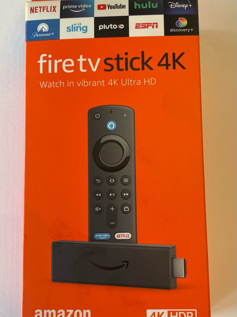 Amazon Fire TV Stick 4K – Orange Box with Black Remote Graphic